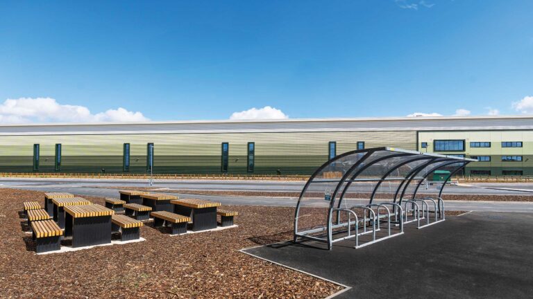 Outdoor breakout area with picnic benches and bike shelter