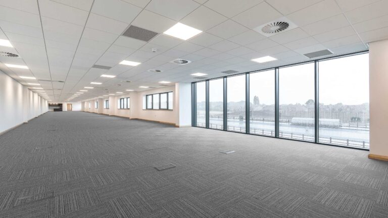 Open-plan first floor office with full-height glazing